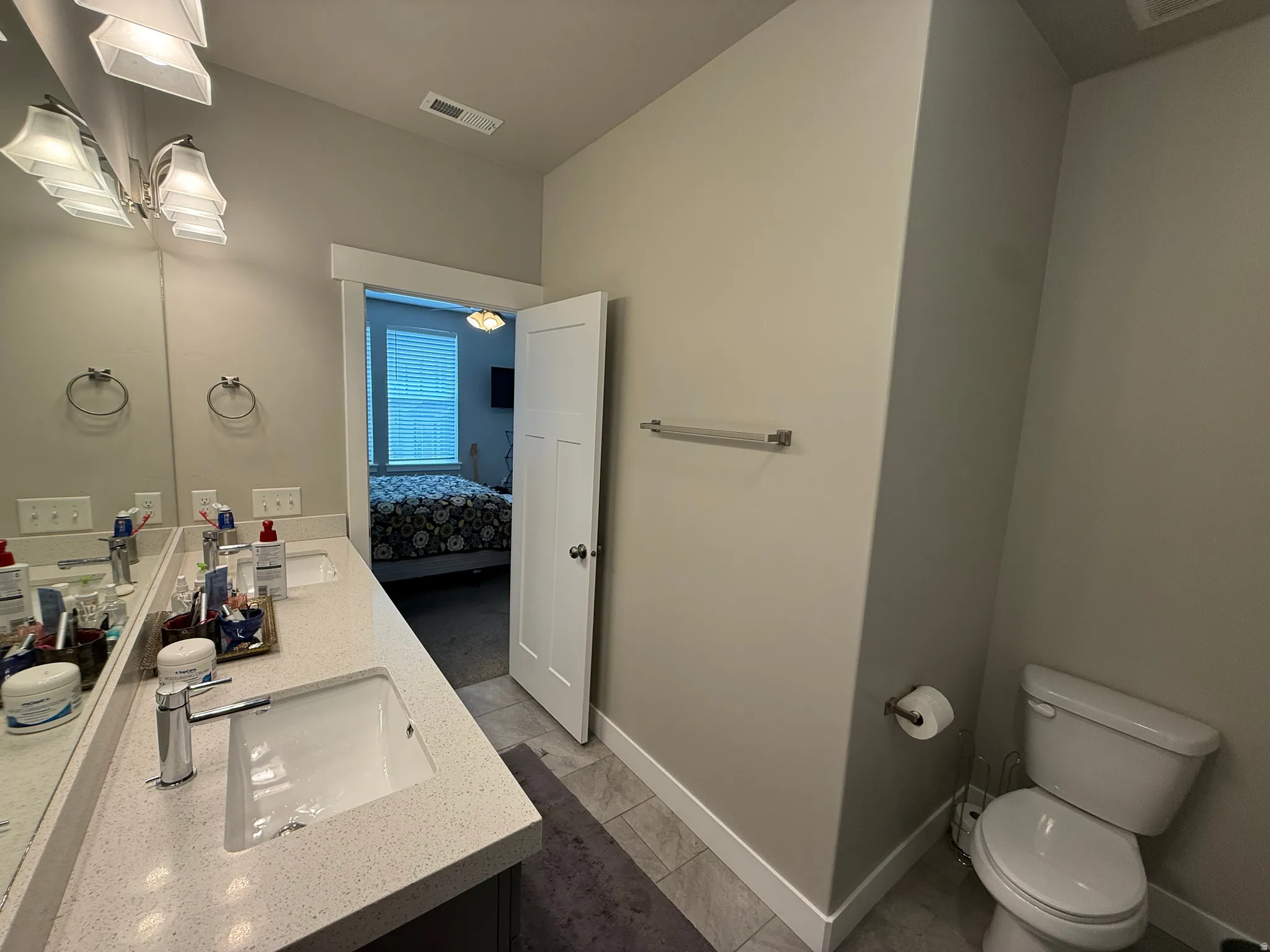 Dual vanity with undermount sinks, quartz-finish countertop, and chrome fixtures