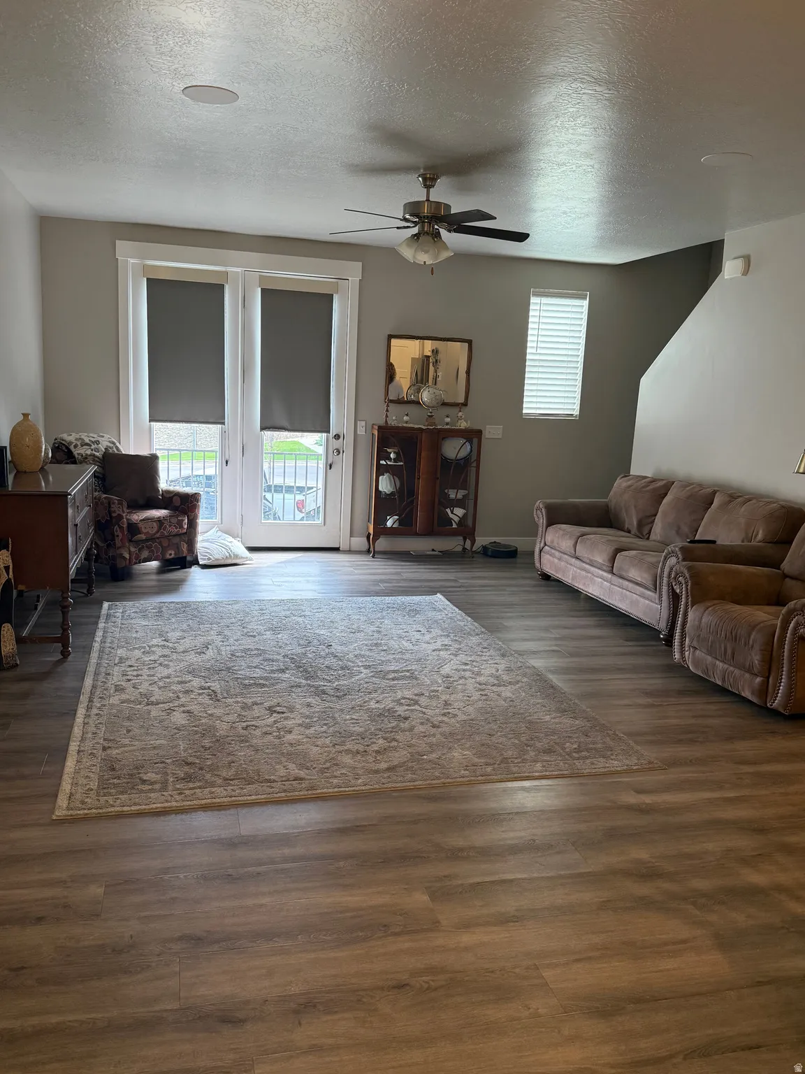 Wood-finish flooring throughout, ceiling fan with integrated lighting, recessed ceiling lighting, and French doors