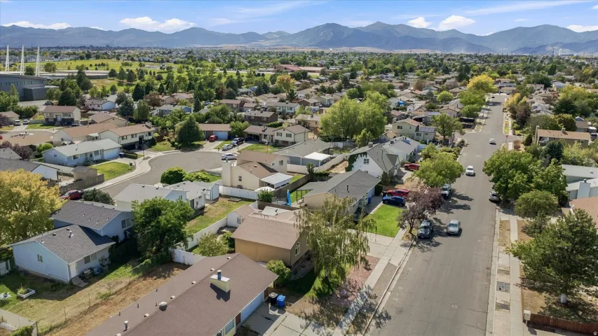 Residential neighborhood with tree-lined streets and mountain backdrop