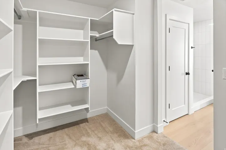 Built-in shelving and hanging rods within the closet area