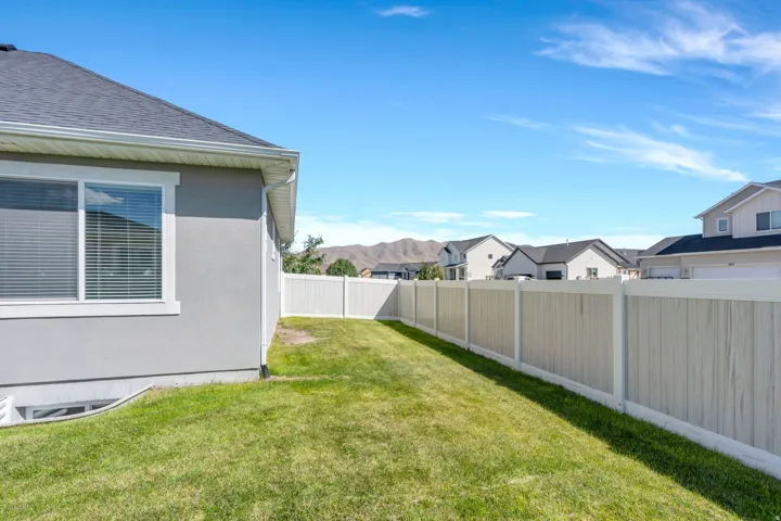 Manicured lawn with a white composite fence