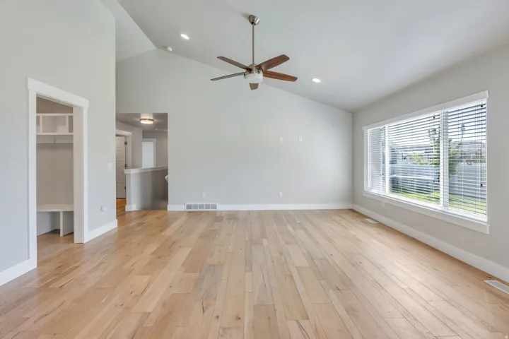 Vaulted ceilings with recessed lighting and a ceiling fan