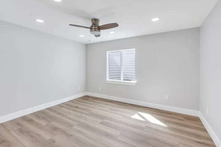 Wood-finish flooring, recessed lighting, ceiling fan, and a window with blinds