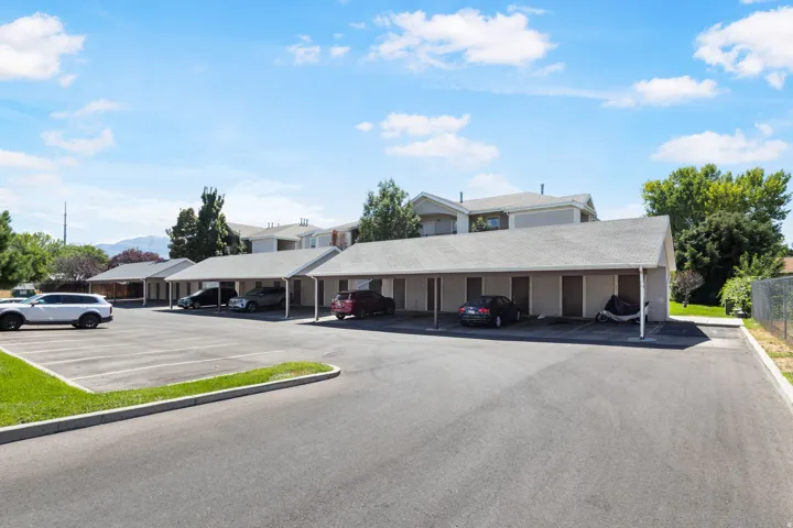 Paved parking lot with multiple covered carport spaces