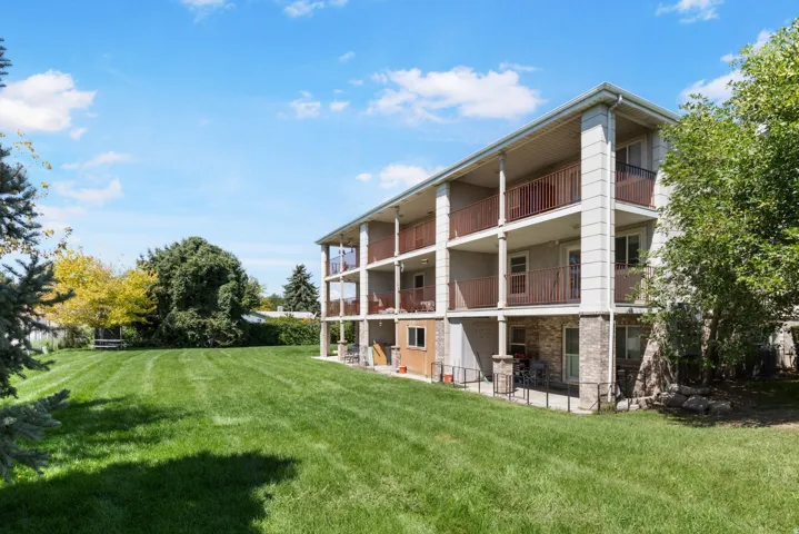 Expansive green space featuring a multi-story building with multiple balconies
