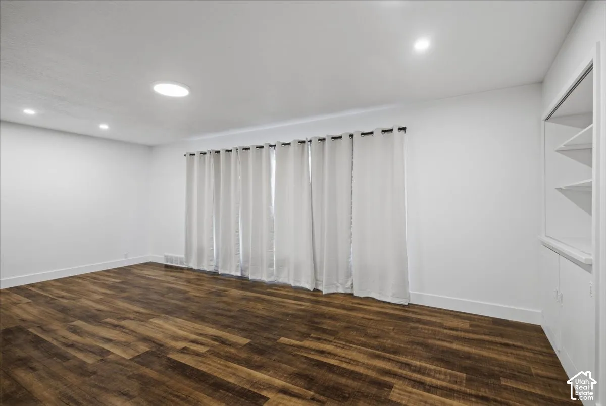 Wood-finish flooring, recessed lighting, and built-in shelving