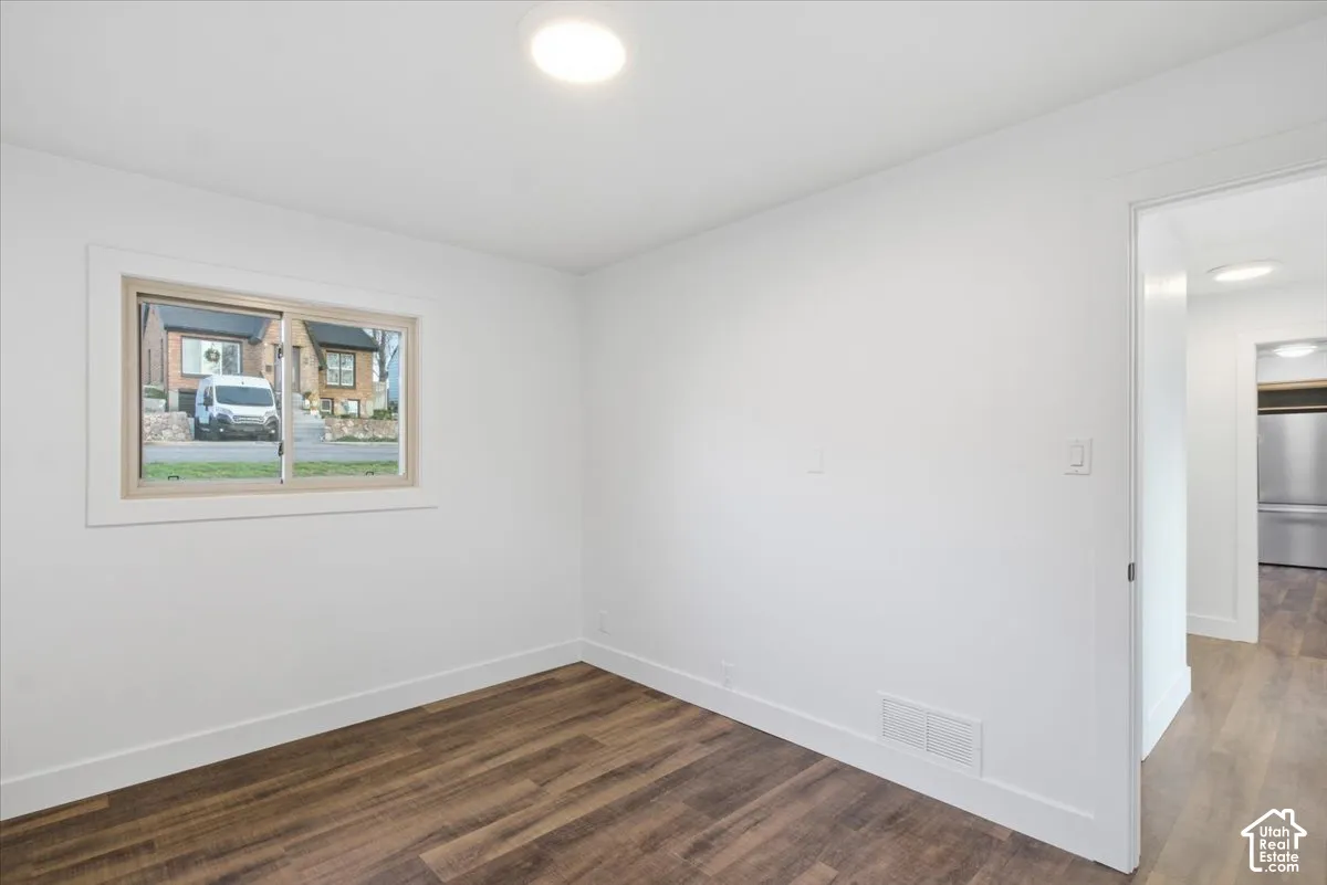 Recessed ceiling lighting, wood-finish flooring, white wall finishes, single-pane window