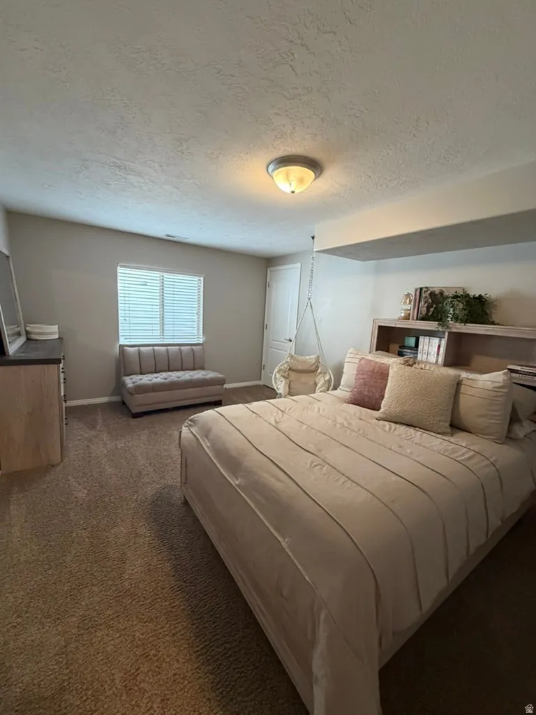 Carpeted flooring, window with blinds, interior door, and overhead lighting
