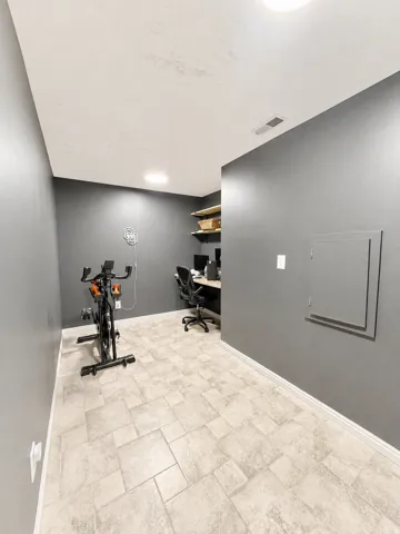 Recessed lighting and a light-toned ceiling highlight the room's height