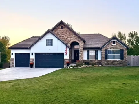 Stone and vertical siding exterior with a dark tile roof