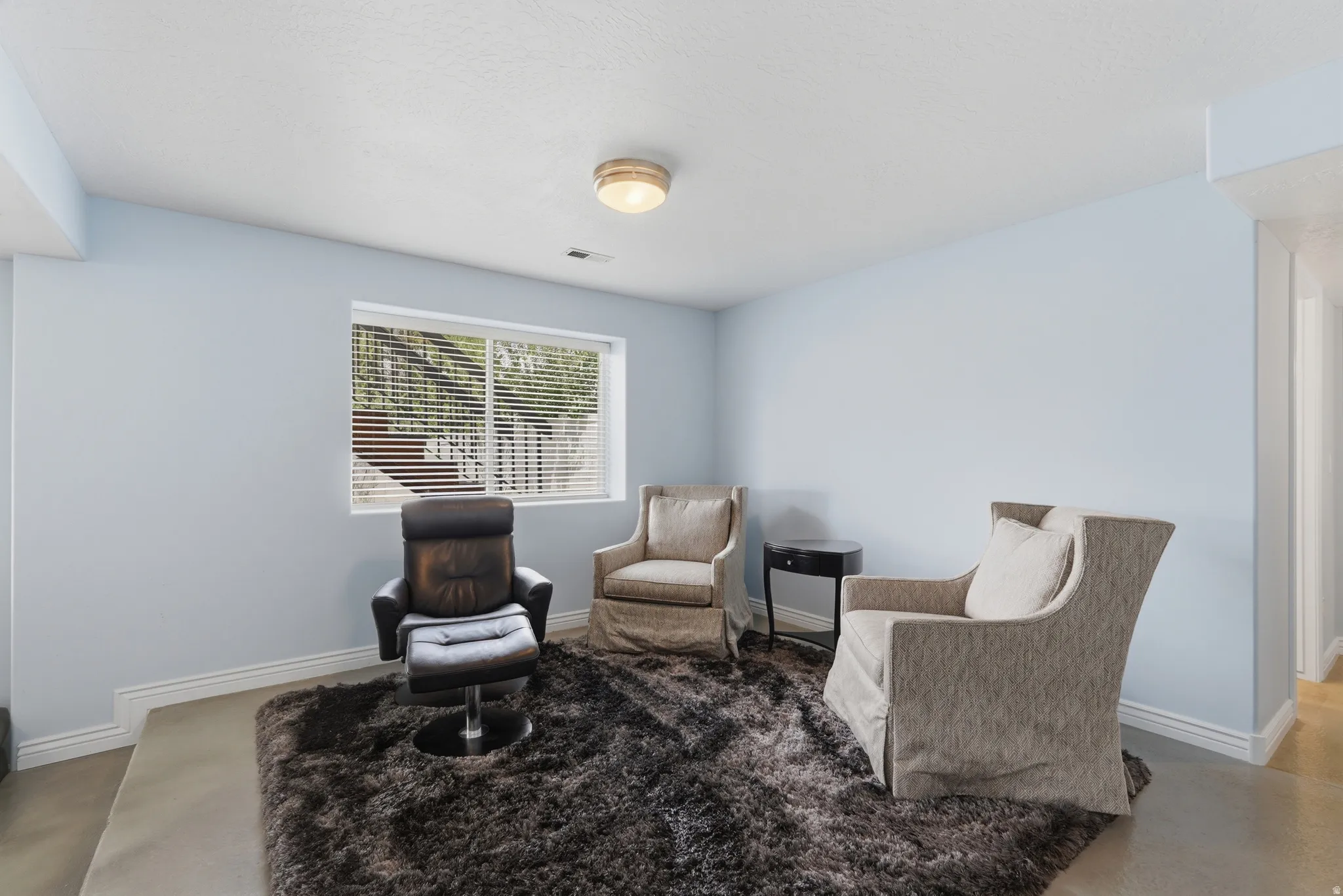 Recessed ceiling, window with blinds, and light-toned walls