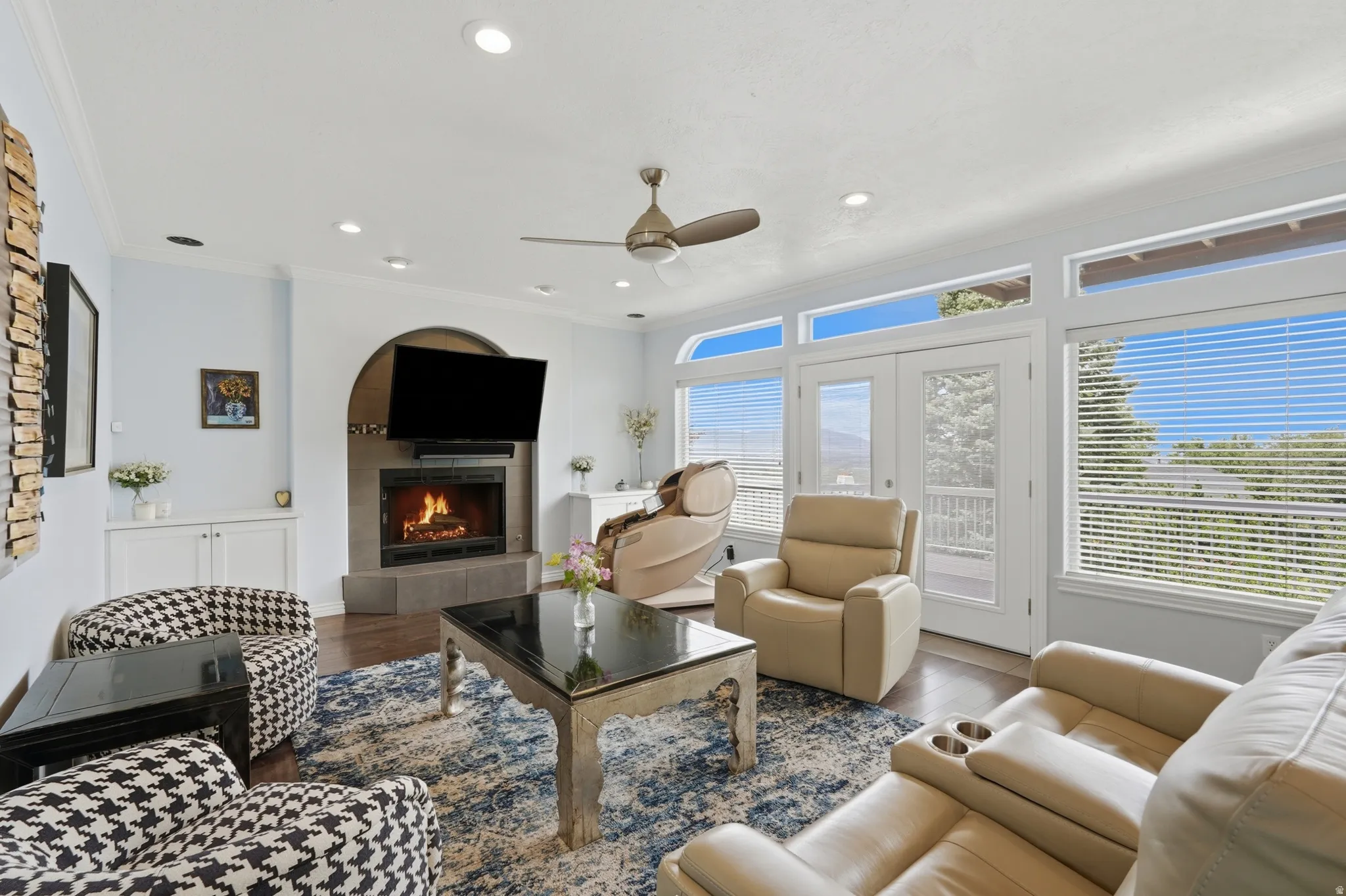 Living area with wood-finish flooring, recessed lighting, and a ceiling fan
