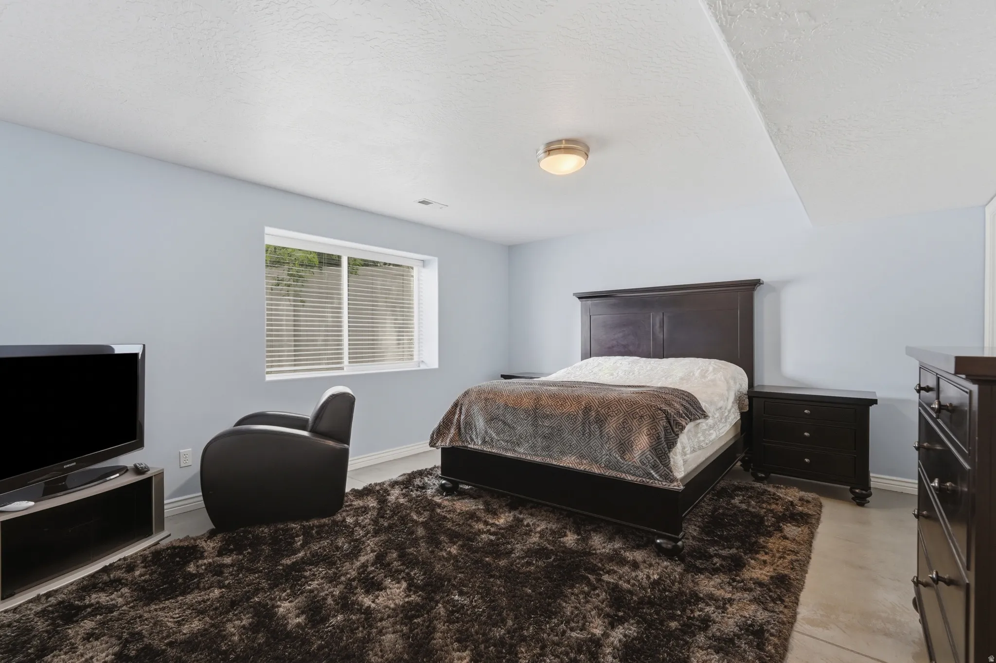 Light blue painted walls with a window featuring horizontal blinds