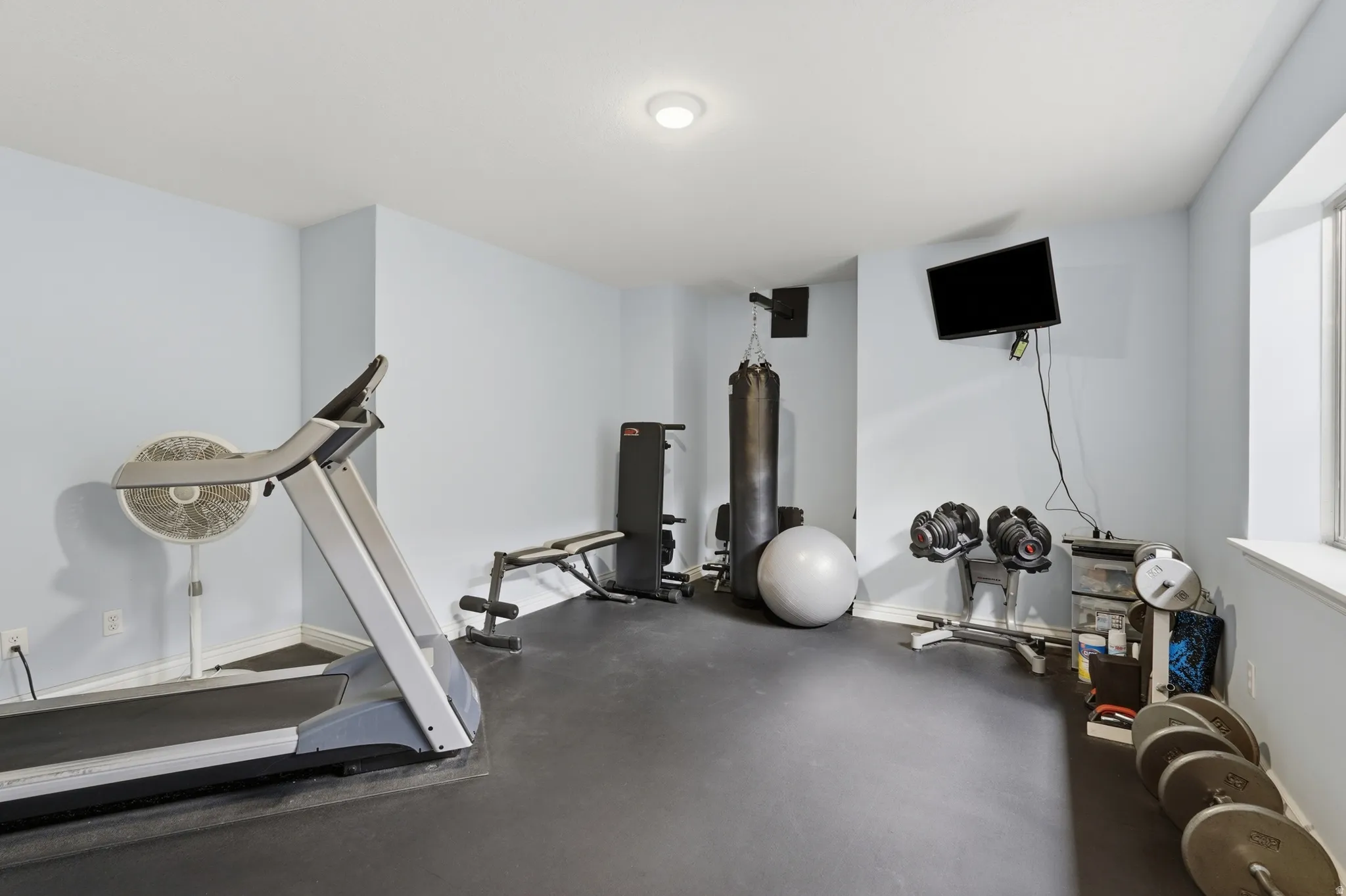 Recessed ceiling lighting, light-toned wall paint, and a window provide illumination