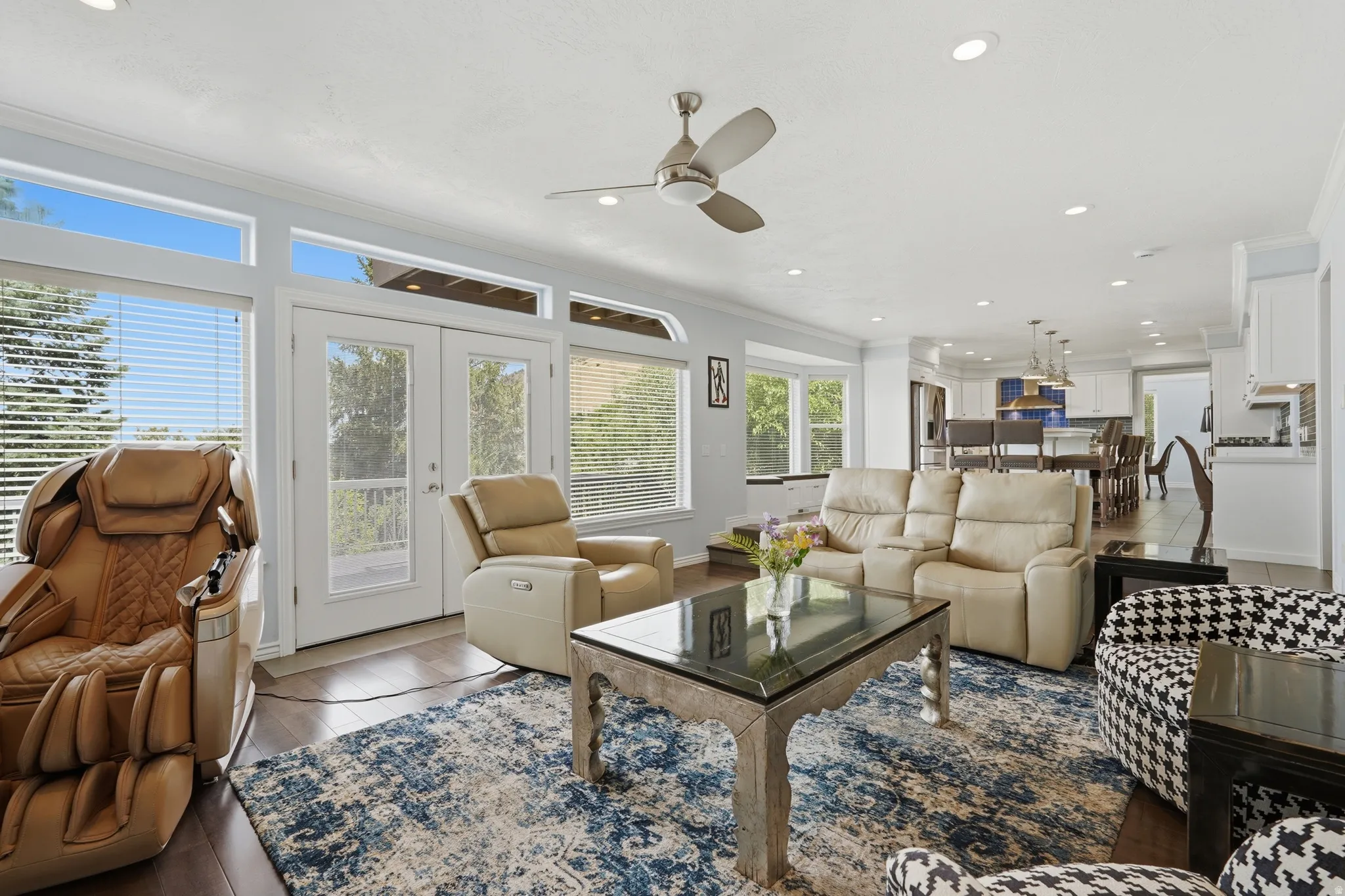 Open-concept living area with dark wood-finish flooring, recessed lighting, and a ceiling fan