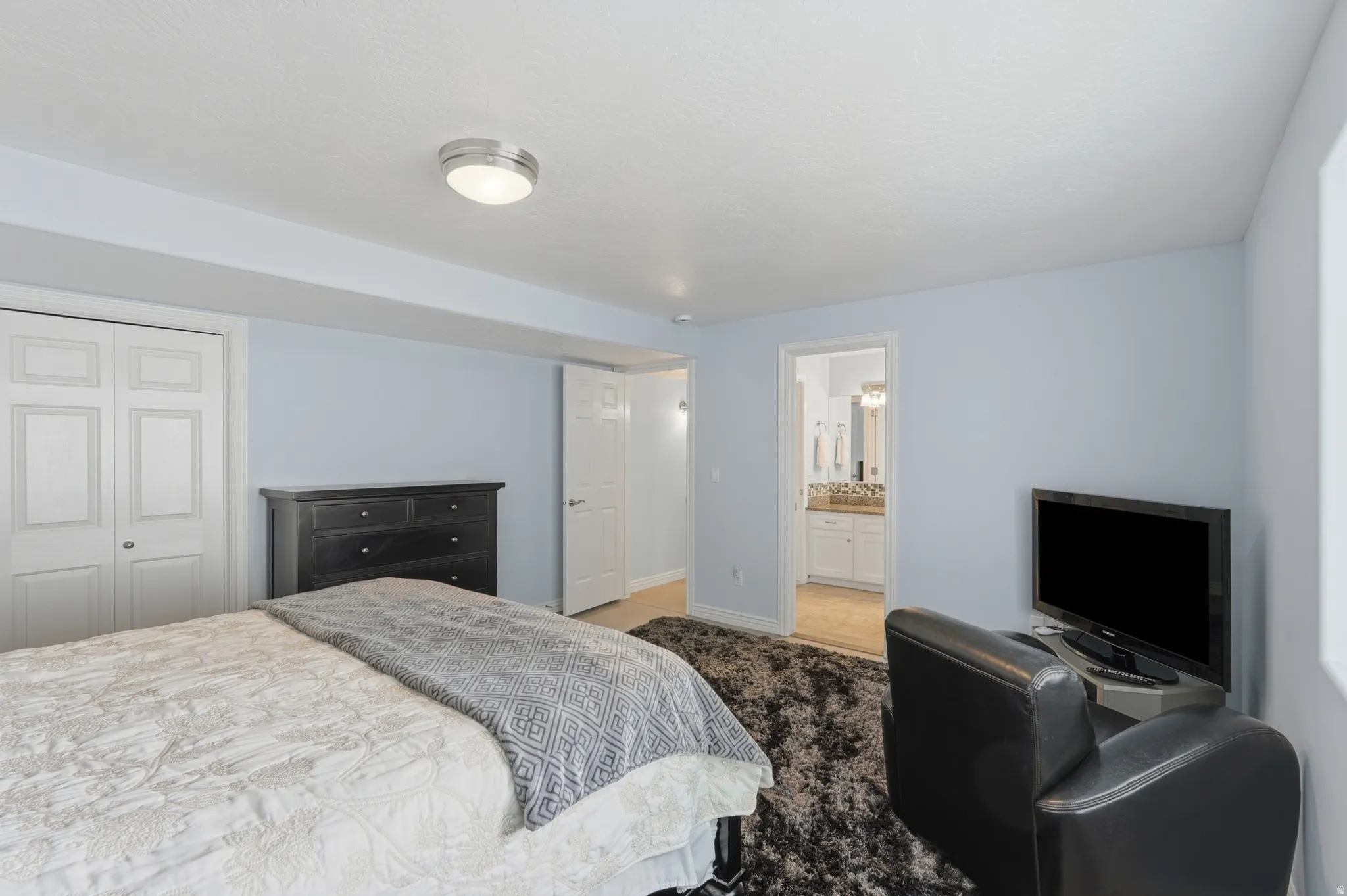 Recessed lighting, light-toned wall finish, white bi-fold closet doors, white paneled interior doors, and a neutral ceiling finish