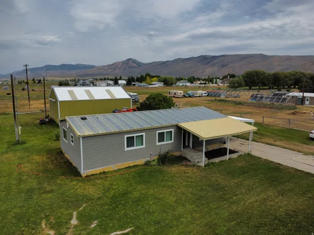 Single-story structure with a metal roof and gray siding
