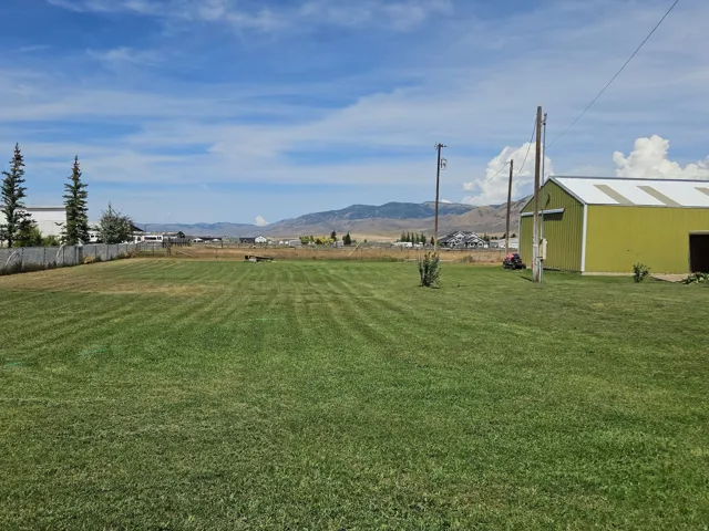Expansive green lawn with mountain backdrop