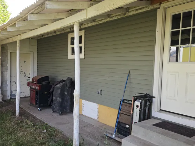 Covered concrete patio with a corrugated roof
