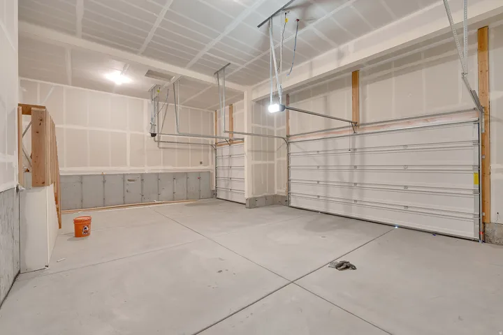 Two overhead garage doors and a concrete floor