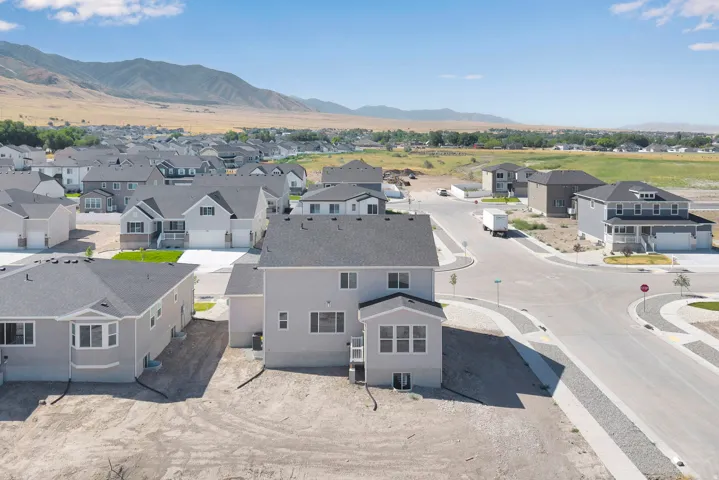 Newly constructed residential area featuring a distinct gray exterior and mountain backdrop