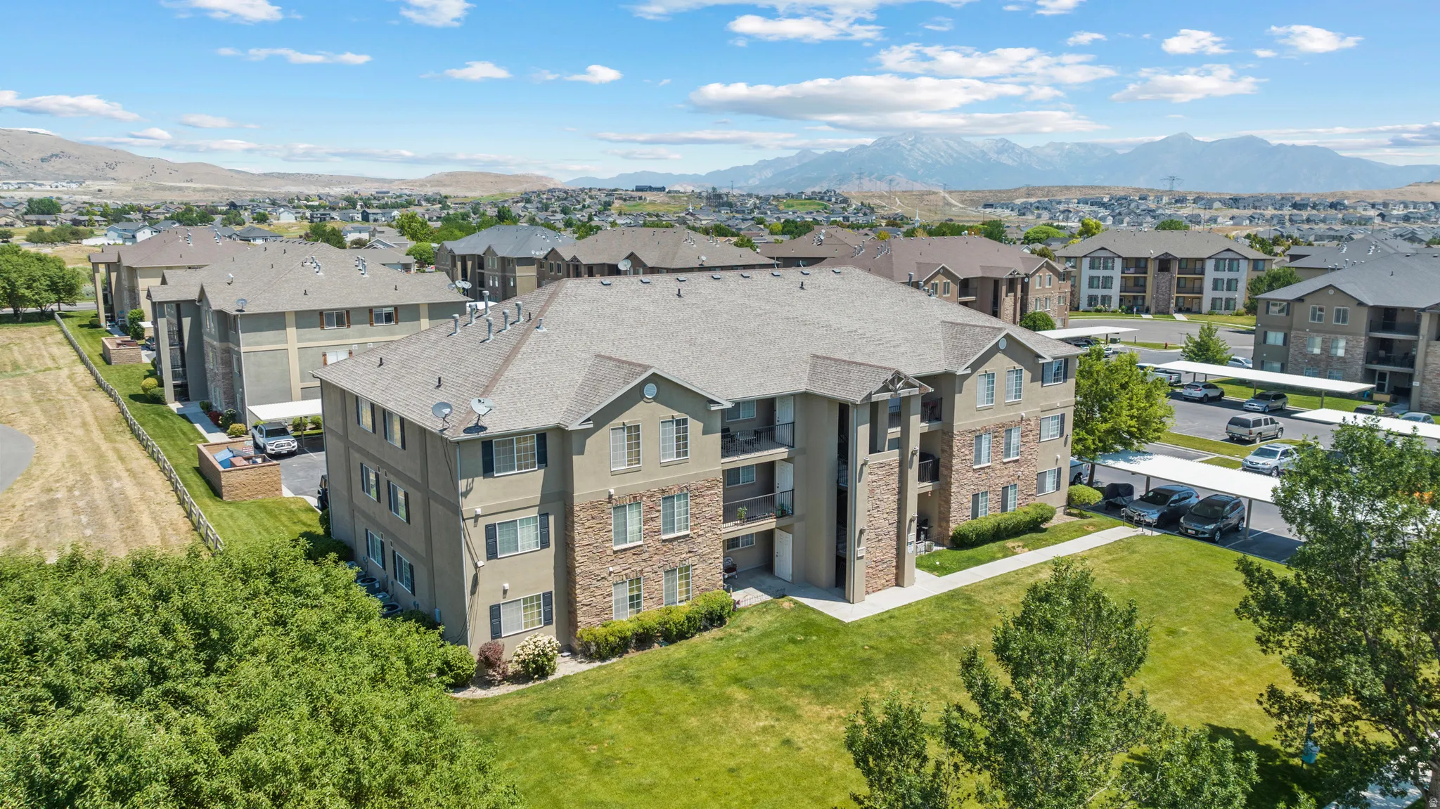 Multi-story residential buildings featuring stone and stucco exteriors, pitched roofs, and balconies