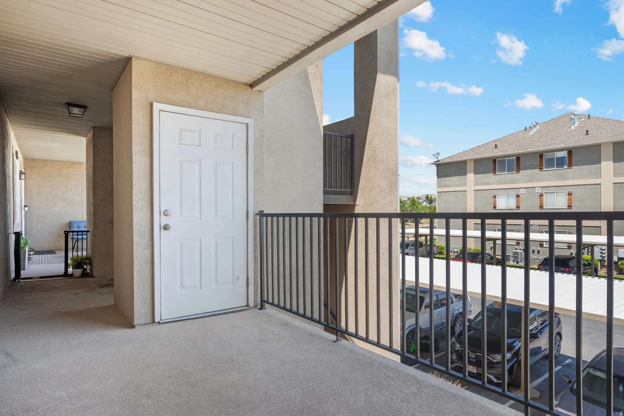 Private balcony with a concrete surface and black metal railing