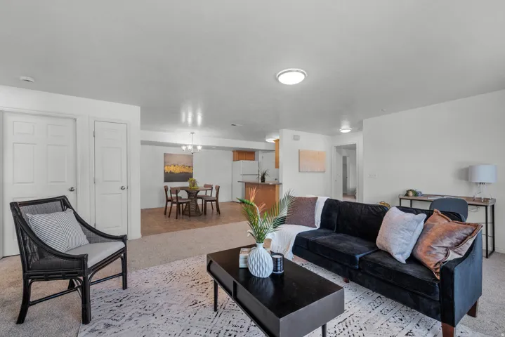 Open-concept living area with carpet flooring and recessed lighting