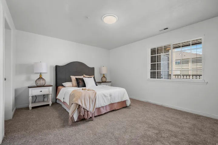 Wall-to-wall carpeting and white walls