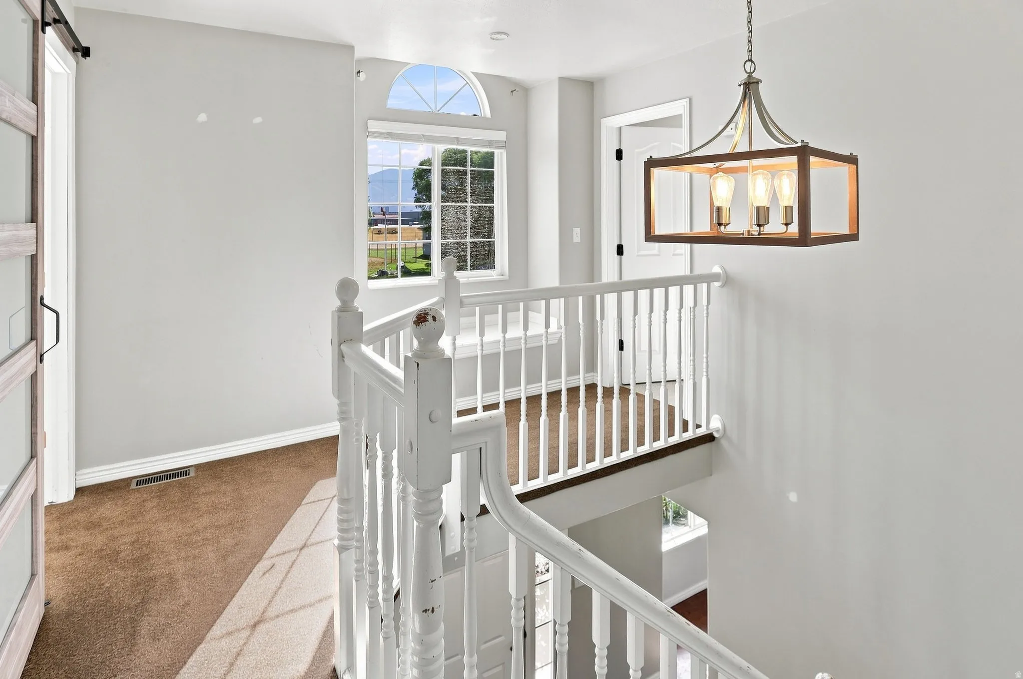 White baluster railing with wood-finish top rail