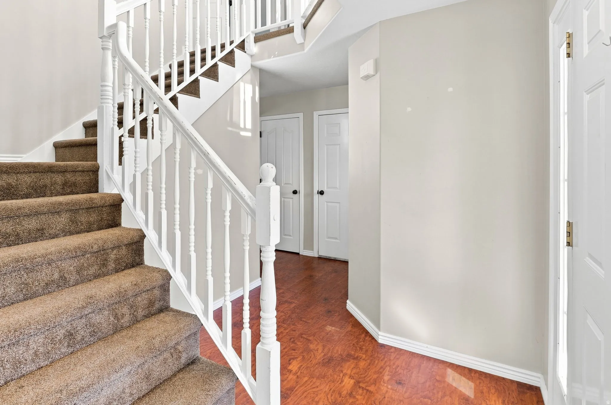 White baluster staircase with carpeted treads