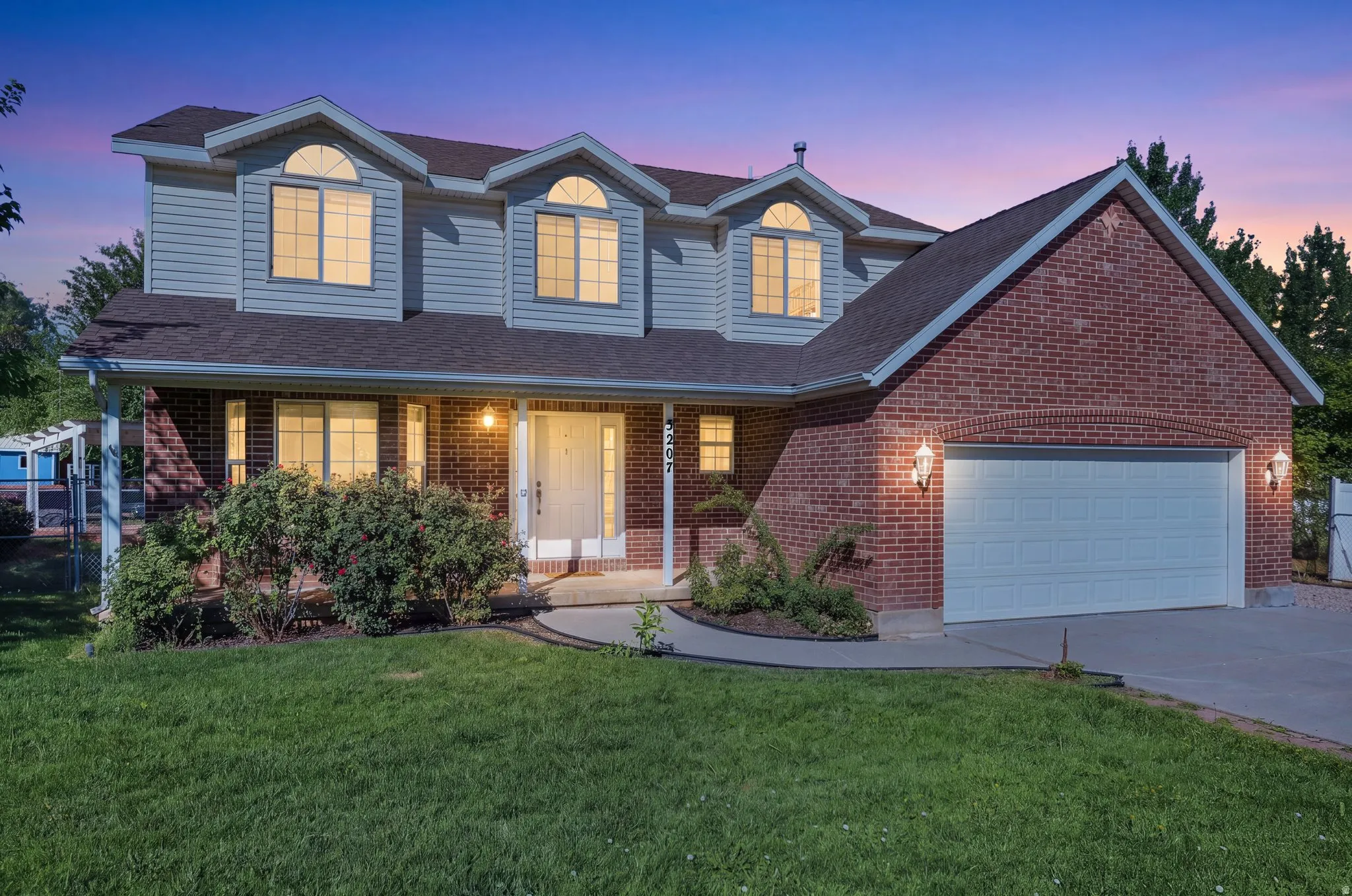 Brick and siding exterior with a two-car garage