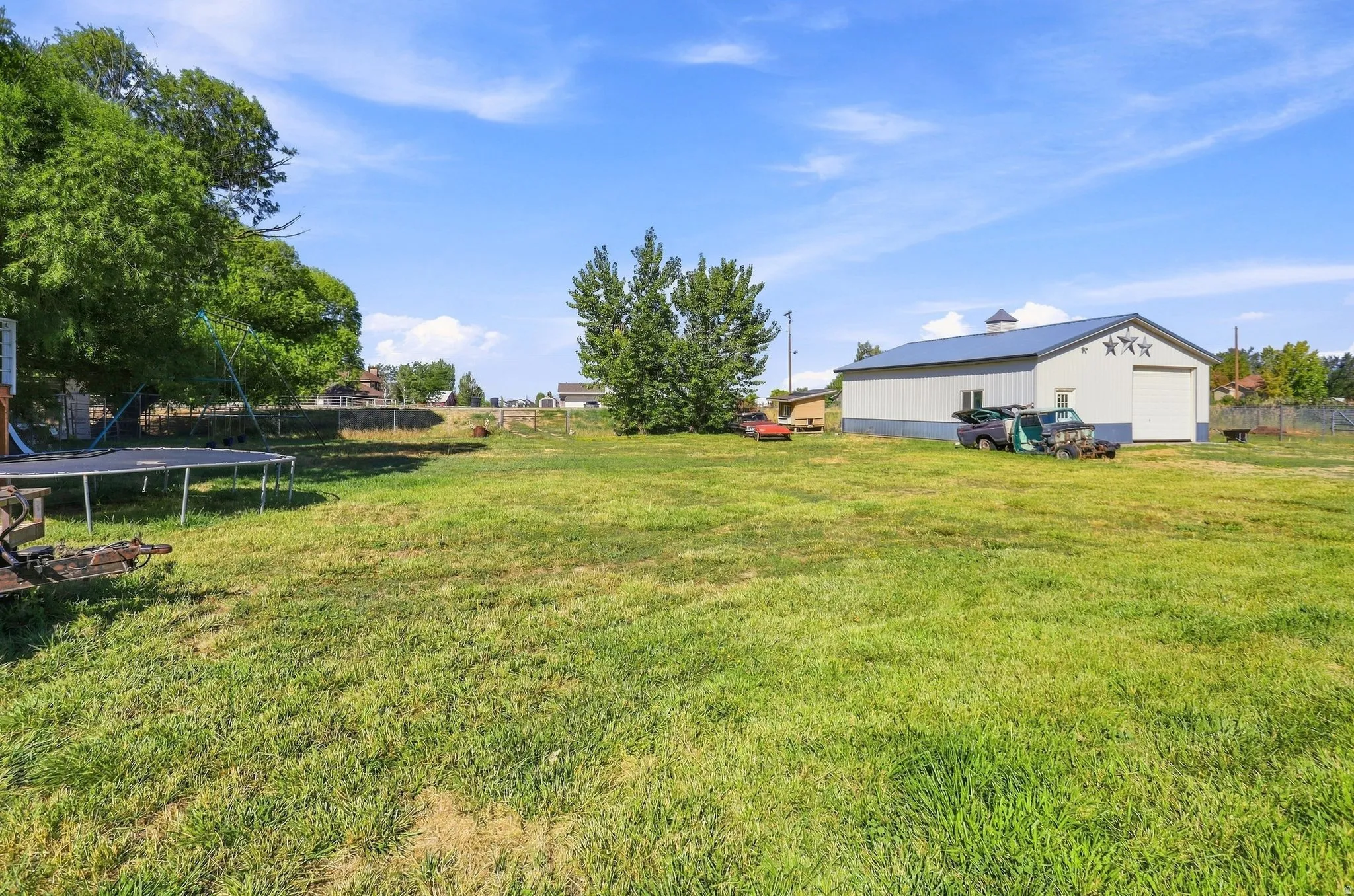 Expansive grassy yard with mature trees