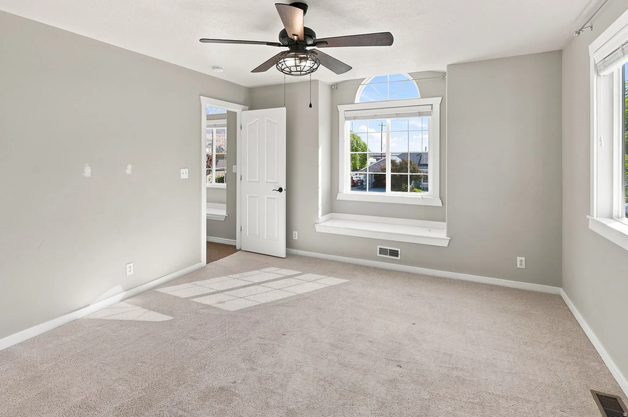 Carpeted interior with light gray wall finishes and white trim