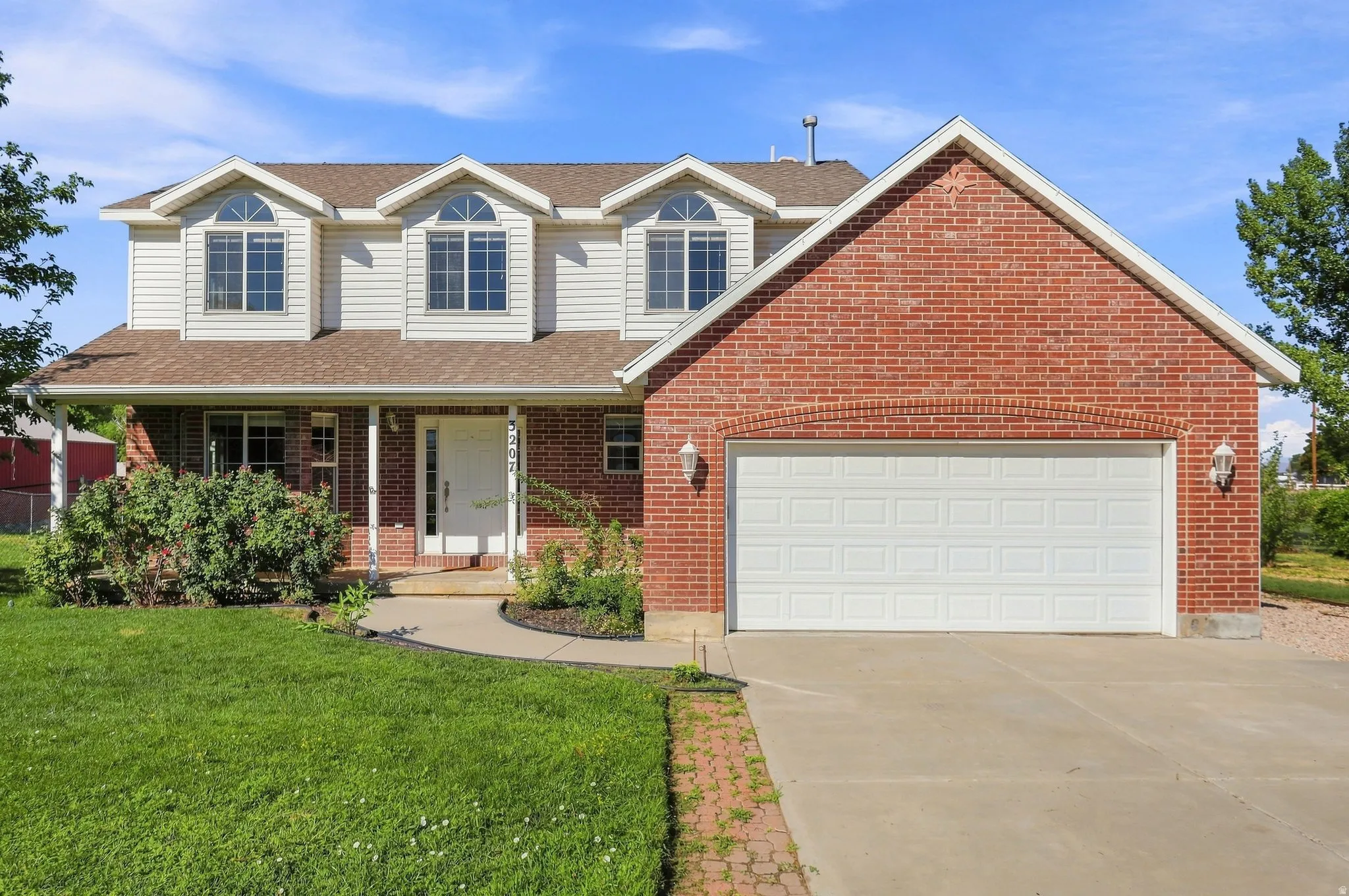 Brick and siding exterior with a covered front porch