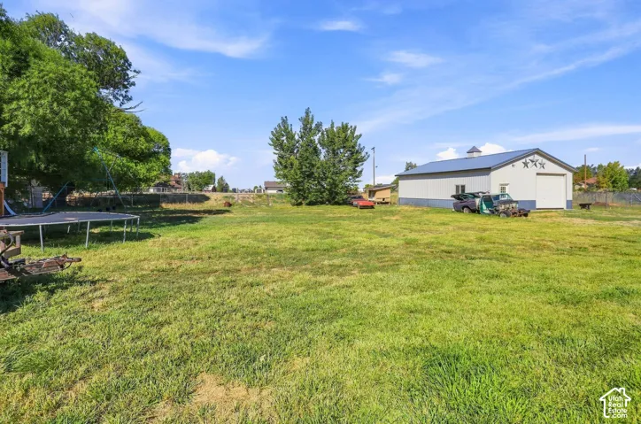 Expansive grassy yard with mature trees