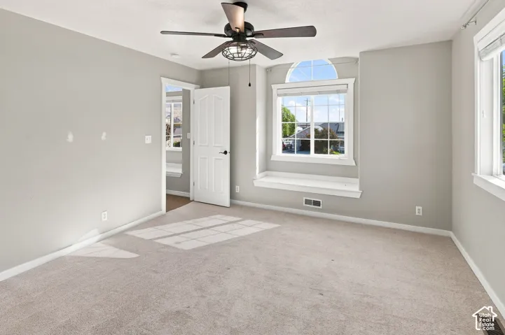 Carpeted interior with light gray wall finishes and white trim