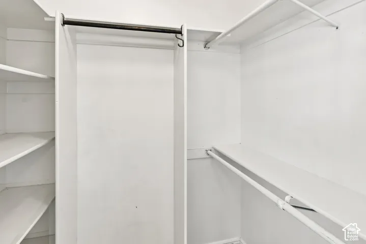 White closet system featuring multiple shelves and hanging rods