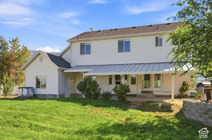 White vinyl siding exterior with a dark shingle roof