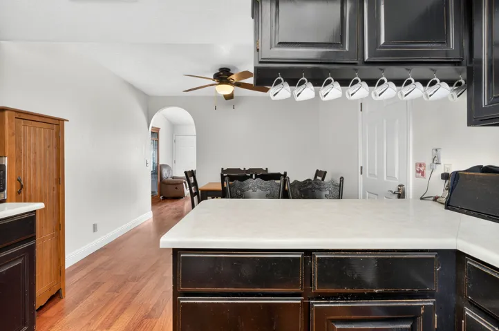 Kitchen island with a light-toned countertop and dark cabinetry
