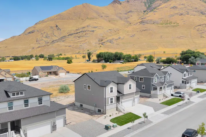 Modern residential architecture with a neutral color palette, featuring a multi-level design and an attached garage