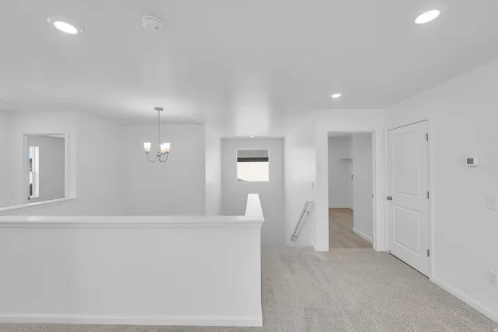 Recessed lighting, chandelier, and a carpeted floor