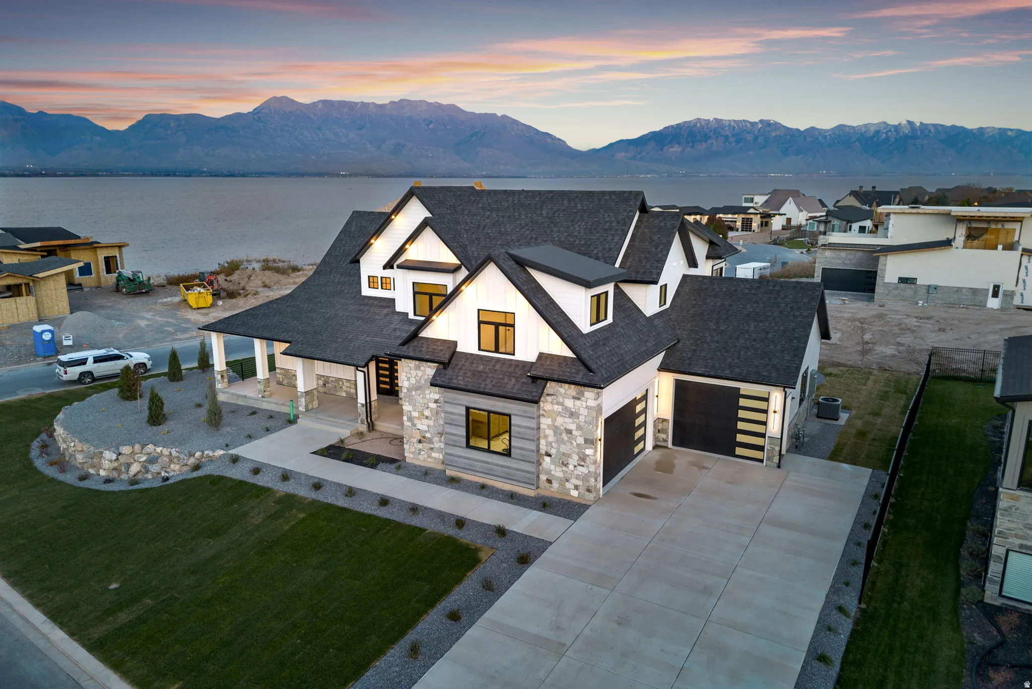 Modern facade featuring a combination of horizontal siding and stacked stone accents
