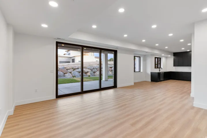 Wood-finish flooring throughout, complemented by recessed lighting