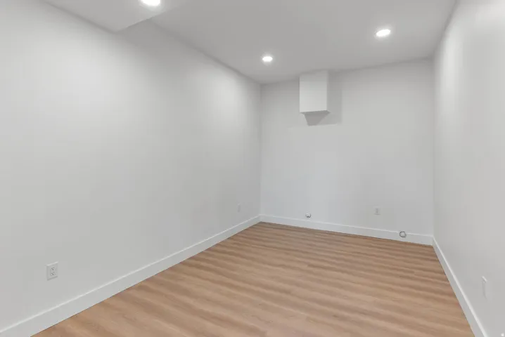 Recessed lighting, light wood-finish flooring, white walls, and a white ceiling