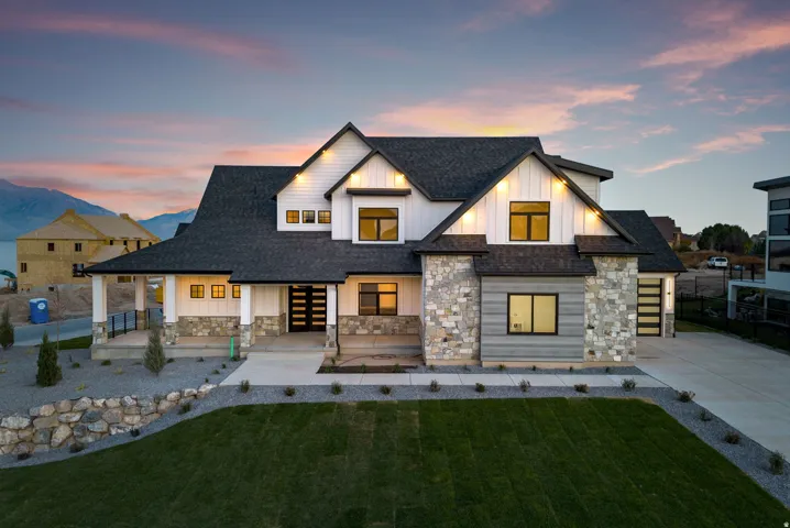 Contemporary exterior with board and batten siding, stone accents, and a dark shingle roof