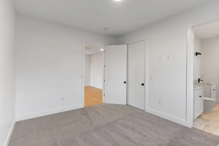Light grey carpeted flooring paired with crisp white walls