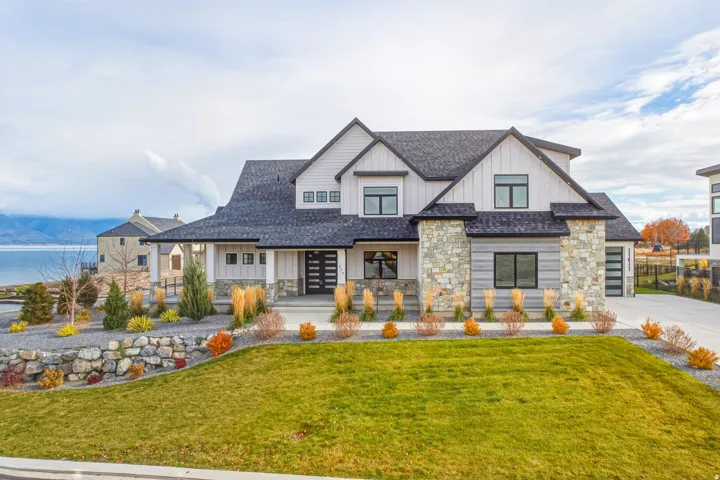 Exterior featuring stone and siding finishes