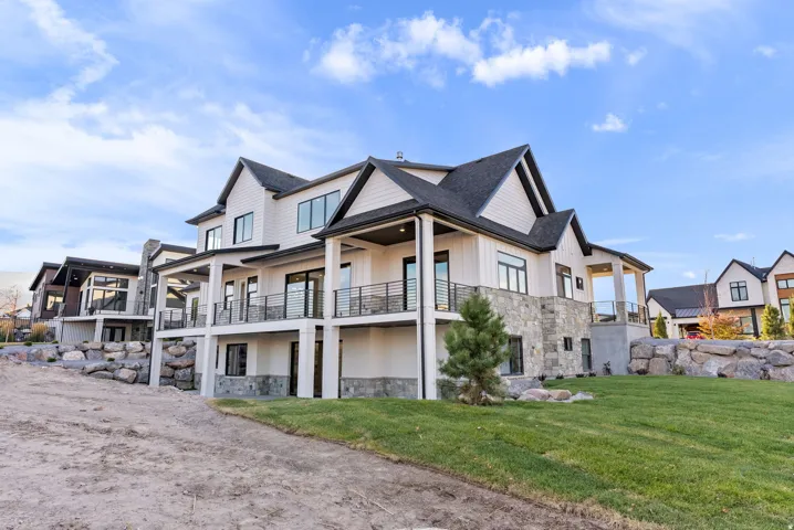Multi-level exterior with board and batten siding and stone accents