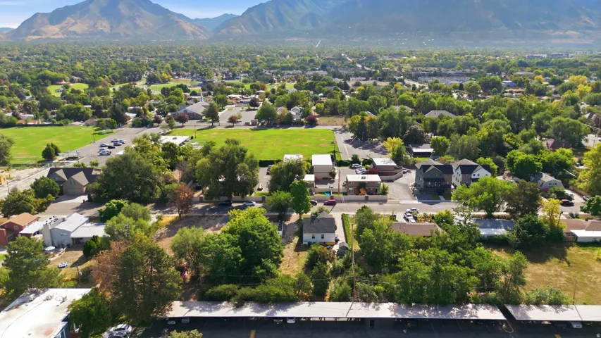 Expansive residential area with mountain backdrop, established trees, and open green spaces